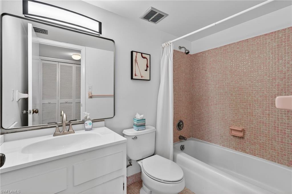5 High Point Circle West, Unit 303 Naples, FL 34103 - Photo 23 of 36 a bathroom with a sink toilet and shower