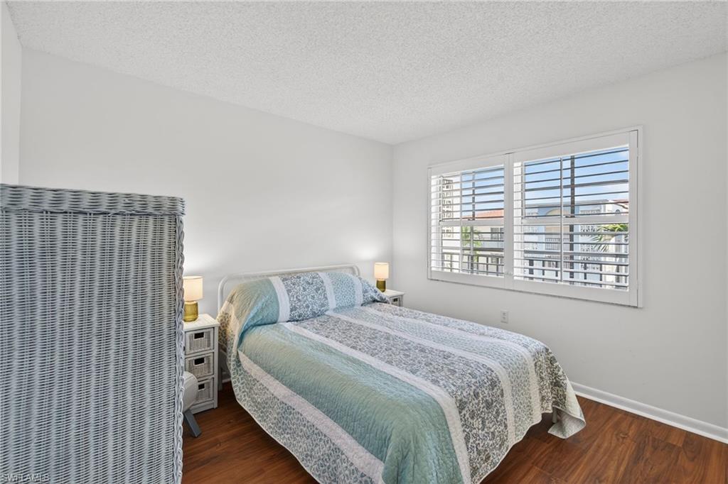 5 High Point Circle West, Unit 303 Naples, FL 34103 - Photo 25 of 36 a bedroom with a bed and a window
