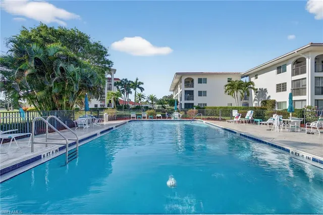 a view of swimming pool with outdoor seating and plants