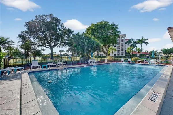 a swimming pool view with a outdoor seating