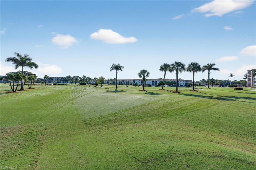 5 High Point Circle West, Unit 303 Naples, FL 34103 - Photo 34 of 36 a view of a golf course with a play ground