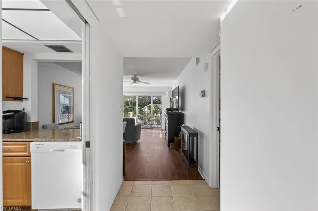 a hallway with a dining table and chairs