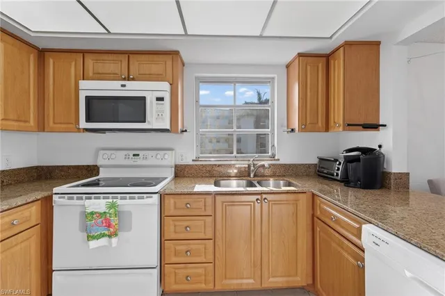 a kitchen with a stove a sink and a microwave