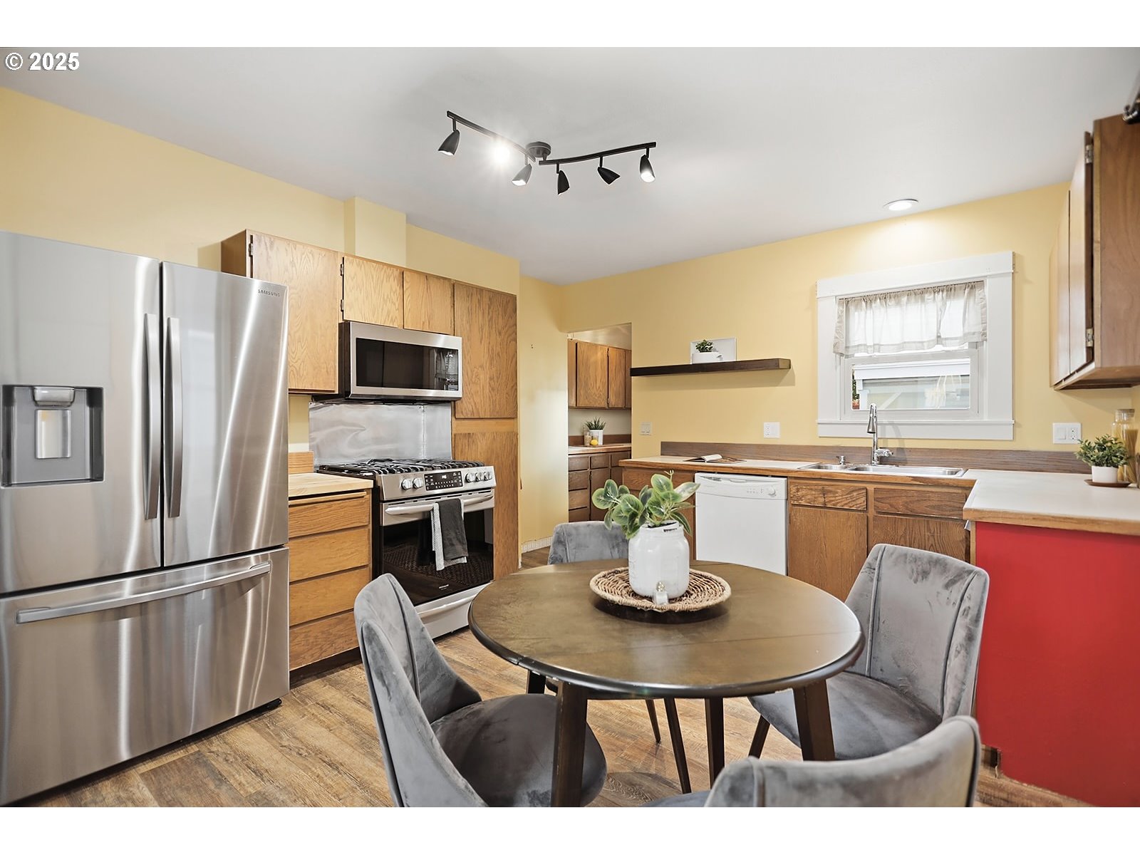 1014 Laughlin Street The Dalles, OR 97058 - Photo 16 of 36 a kitchen with a refrigerator a stove a sink dishwasher with a dining table and chairs