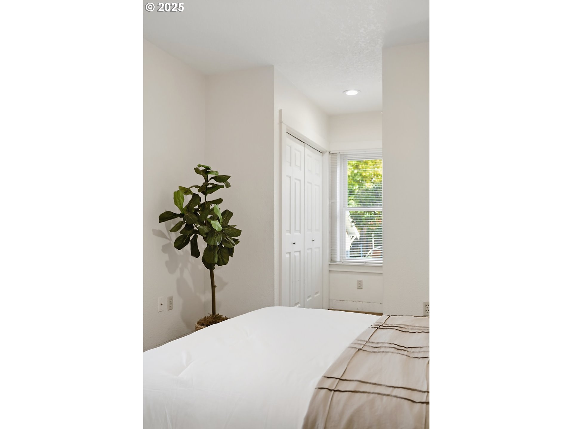 1014 Laughlin Street The Dalles, OR 97058 - Photo 18 of 36 a bedroom with a bed and a potted plant