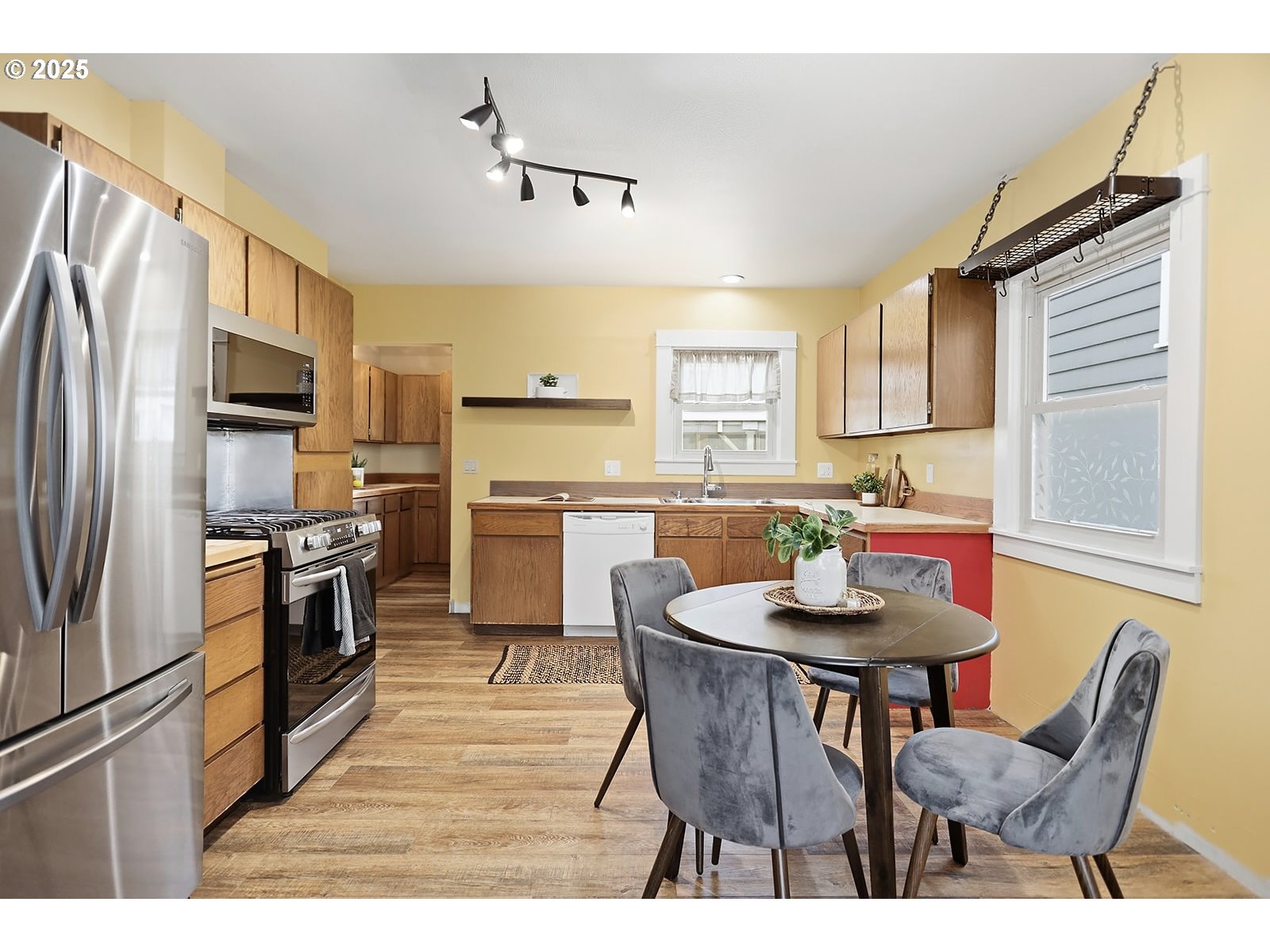 1014 Laughlin Street The Dalles, OR 97058 - Photo 9 of 36 a kitchen with stainless steel appliances granite countertop a dining table chairs refrigerator and microwave