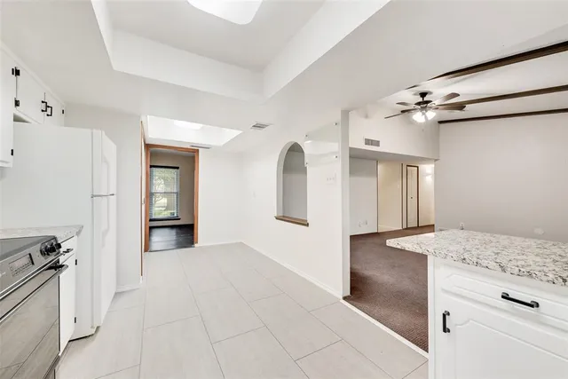 a view of a kitchen cabinets and refrigerator