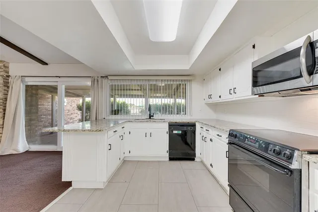 a kitchen with stainless steel appliances granite countertop a stove and a sink