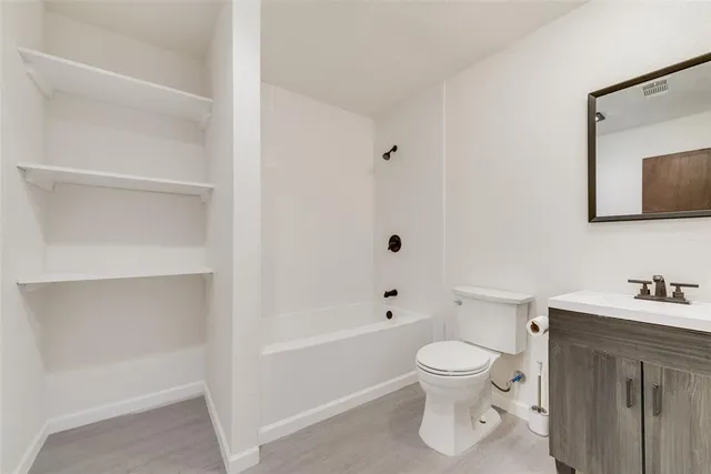 a bathroom with a toilet a sink and a bathtub