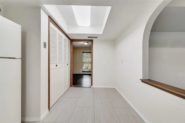 a view of a hallway with wooden floor and entryway