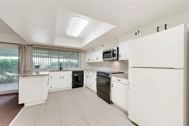 a kitchen with stainless steel appliances a refrigerator sink and cabinets