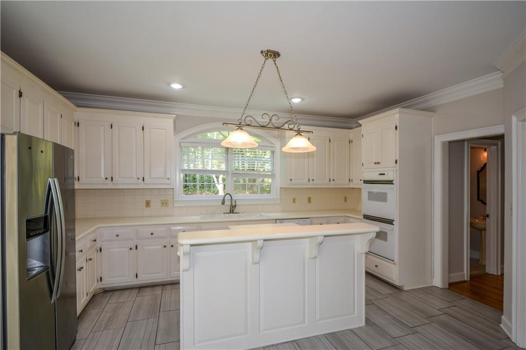40 Waverly Lane Winder, GA 30680 - Photo 15 of 40 a kitchen with a sink a refrigerator a window and cabinets
