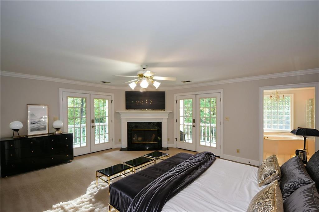 40 Waverly Lane Winder, GA 30680 - Photo 24 of 40 a bedroom with a bed and a fireplace
