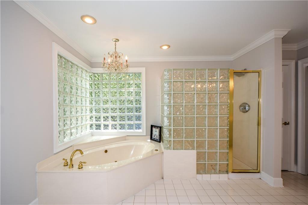 40 Waverly Lane Winder, GA 30680 - Photo 28 of 40 a bathroom with a tub a sink and a large window