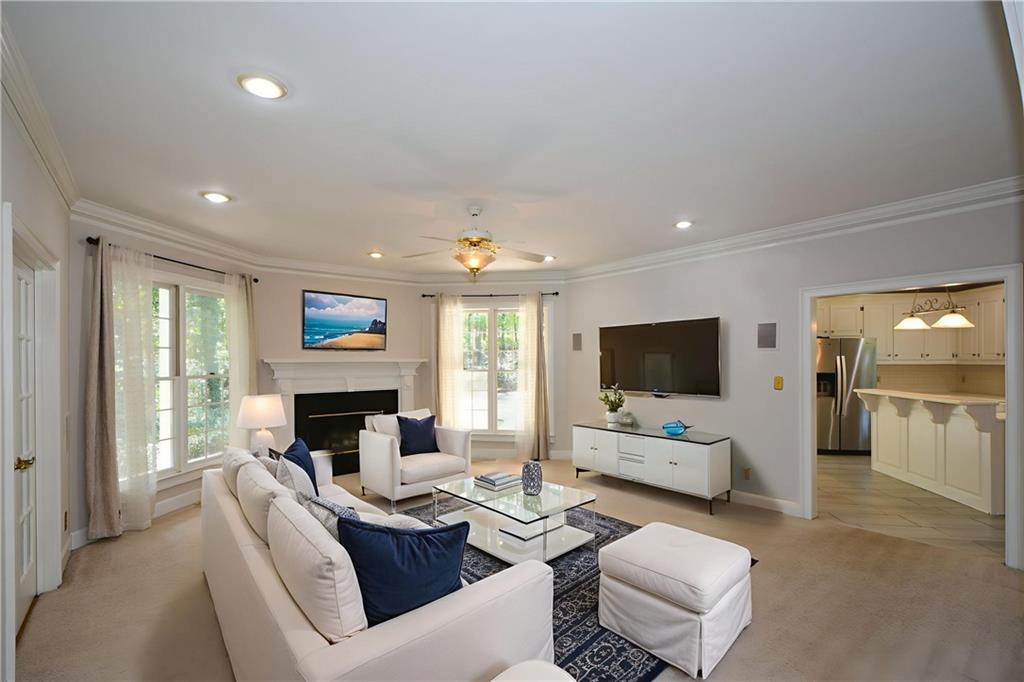 40 Waverly Lane Winder, GA 30680 - Photo 8 of 40 a living room with furniture a flat screen tv and a fireplace