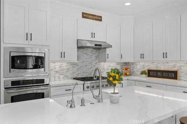 a kitchen with a table chairs refrigerator and wooden floor