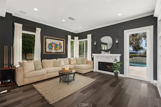 a living room with furniture fireplace and flat screen tv