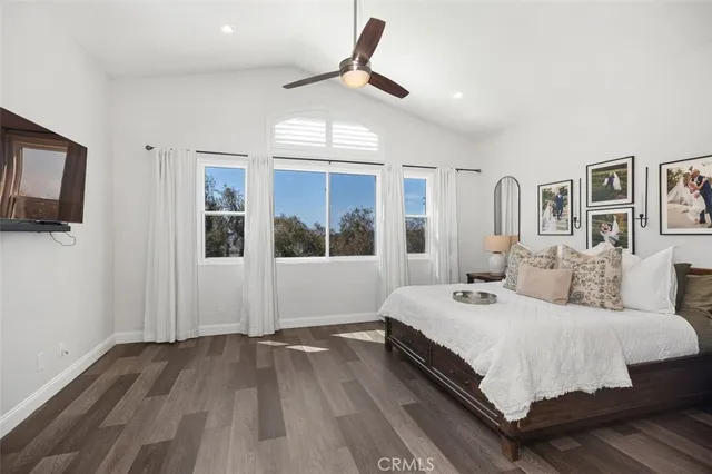 a bedroom with a large bed and a chandelier