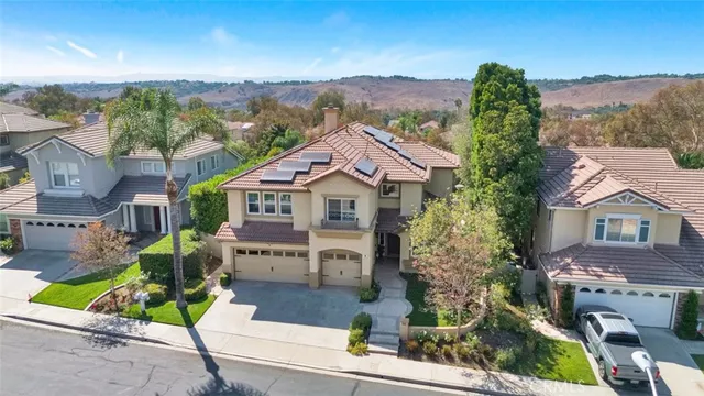 a aerial view of a house with a yard and sitting area