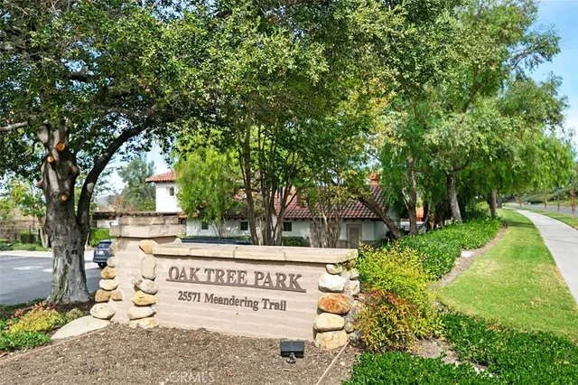 a view of a patio with a table and chairs under an umbrella
