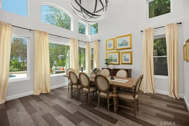 a dining room with furniture window and wooden floor
