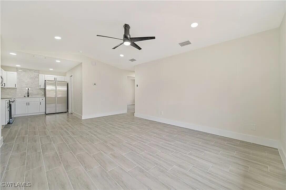 4733 28th Street Southwest Lehigh Acres, FL 33973 - Photo 7 of 10 Living Room and Kitchen