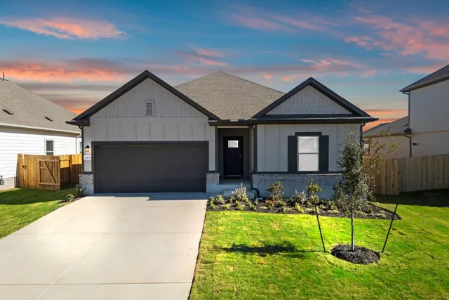 a front view of house with yard and green space