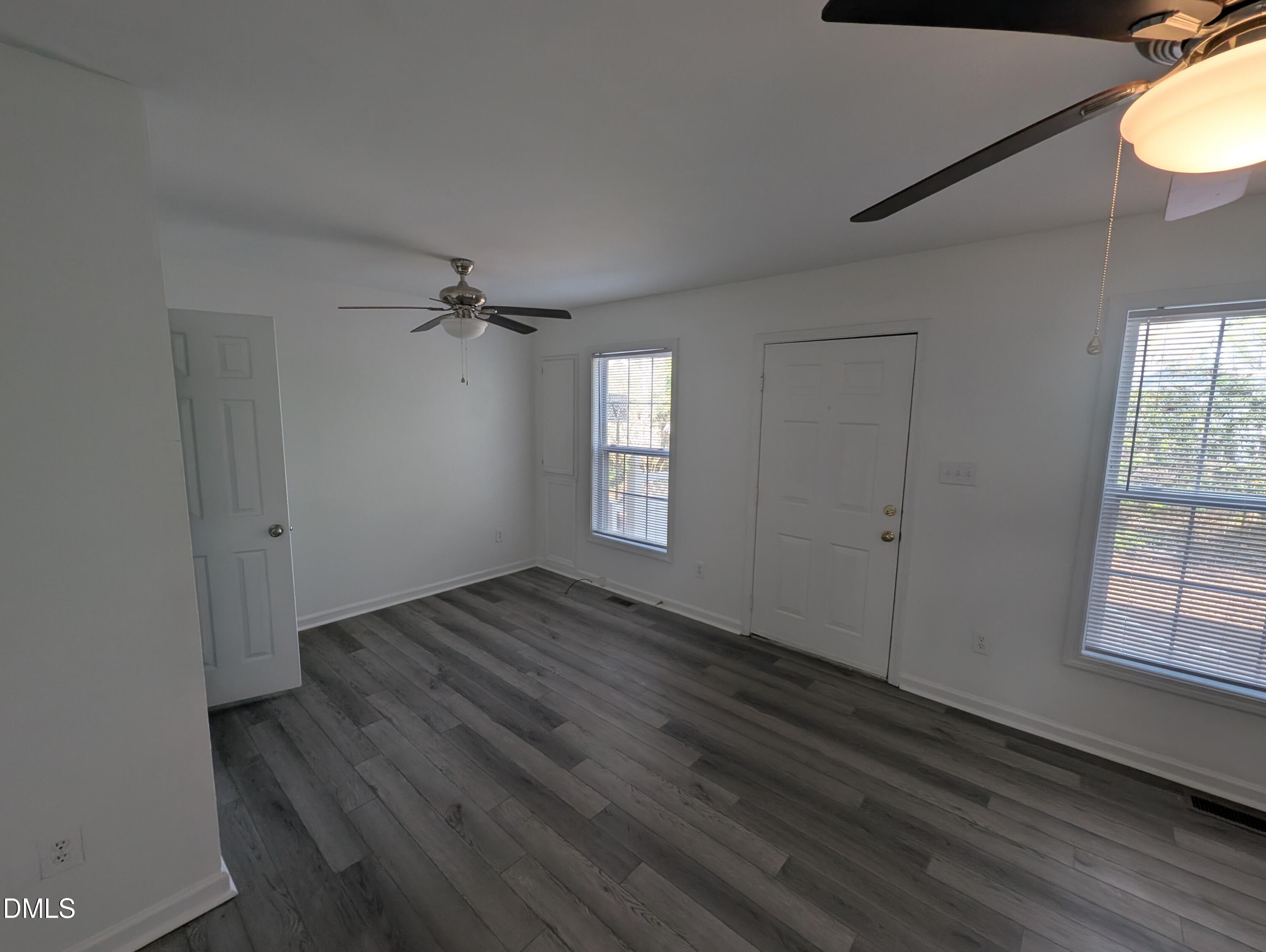 1005 Shades Place Raleigh, NC 27601 - Photo 11 of 18 a view of an empty room with wooden floor and a window
