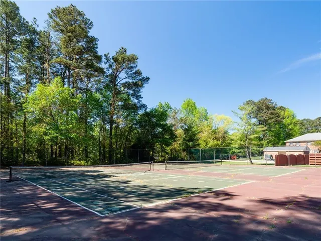 a view of a yard with large trees