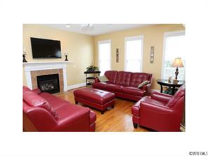 808 Victorian Way Fort Mill, SC 29708 - Photo 7 of 16 a living room with furniture a flat screen tv and a fireplace