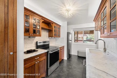 a kitchen with stainless steel appliances granite countertop a stove and a sink