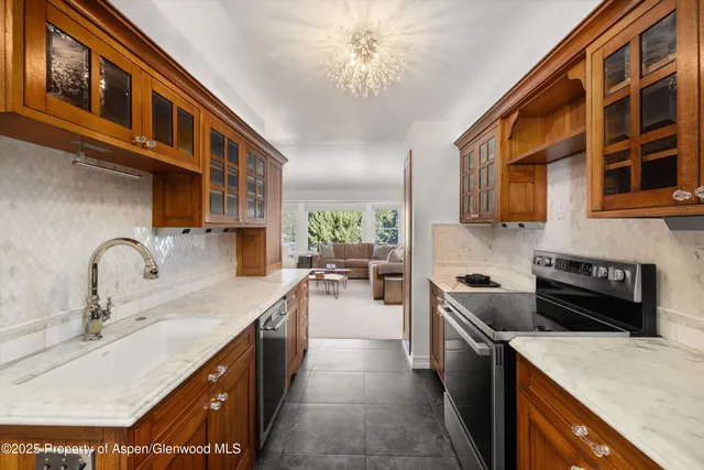 a kitchen with a sink a stove and cabinets