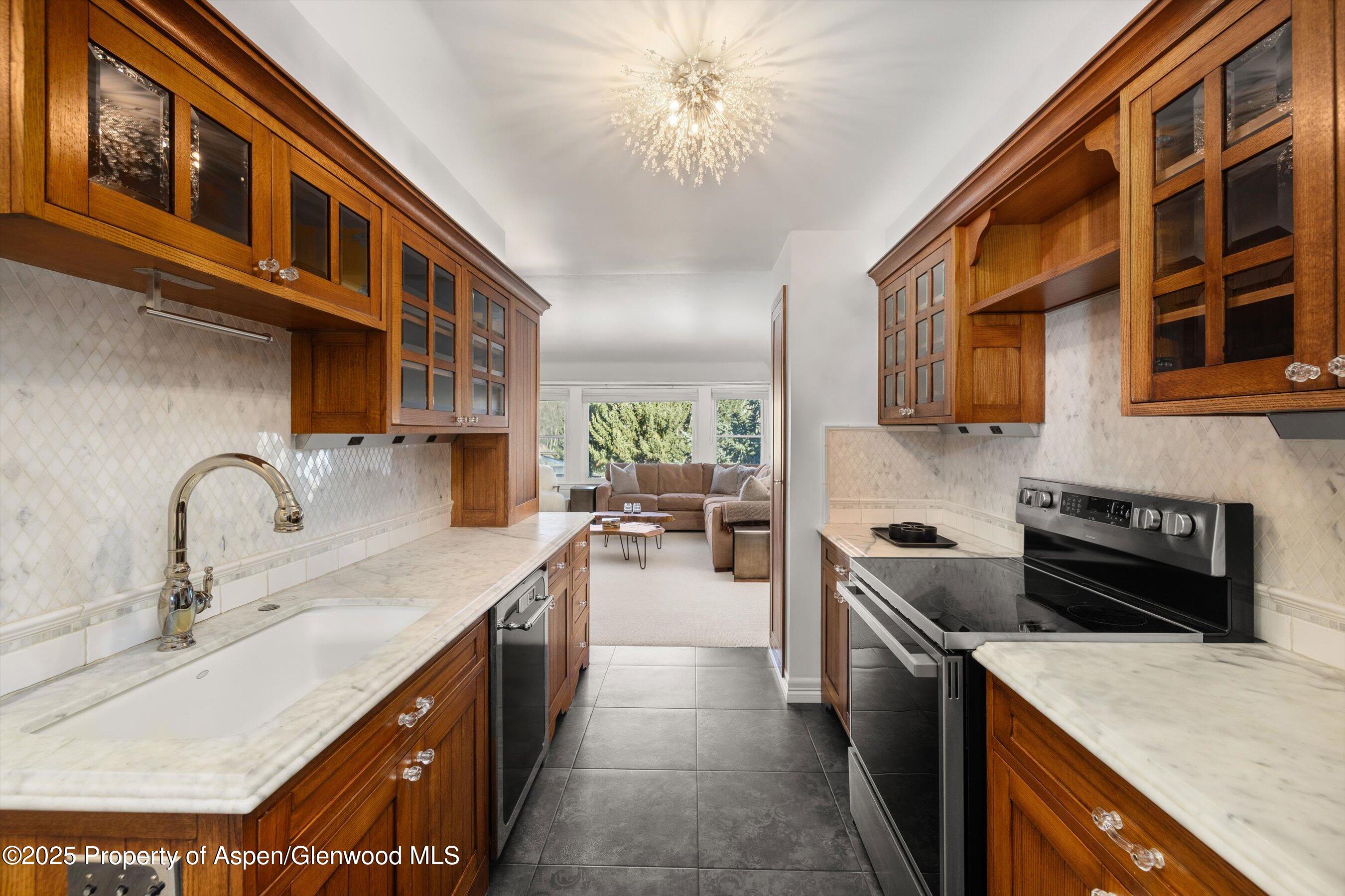 1041 Vine Street Aspen, CO 81611 - Photo 3 of 9 a kitchen with a sink a stove and cabinets