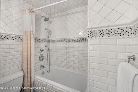 a bathroom with a bathtub and shower