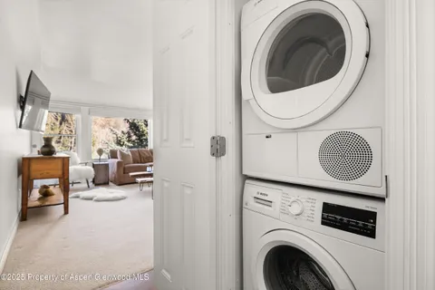 a view of a storage and utility room with washer and dryer