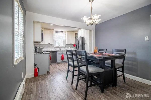 a view of a dining room with furniture and wooden floor