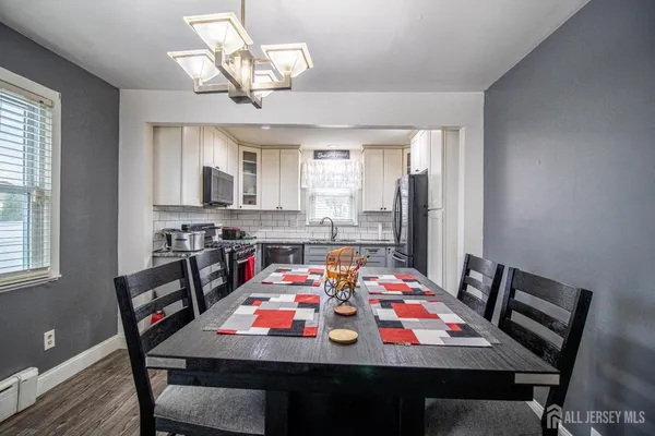 a view of a dining room with furniture and wooden floor