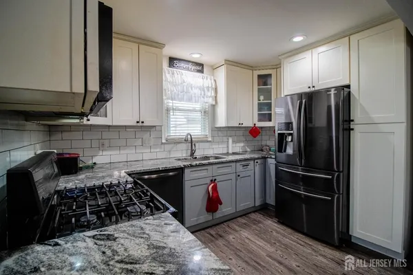 a kitchen with granite countertop stainless steel appliances and wooden cabinets
