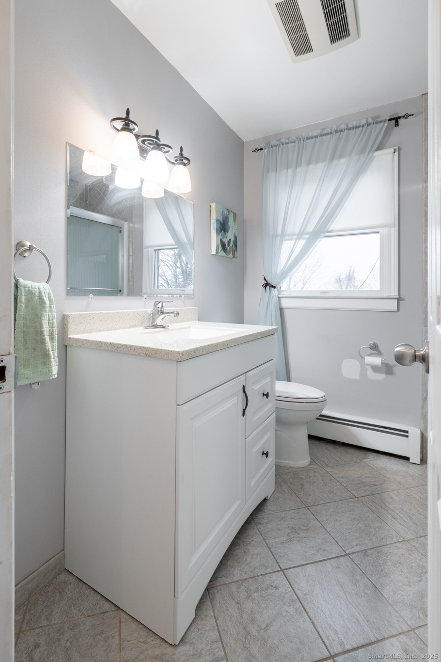 93 Tawny Thrush Road Naugatuck, CT 06770 - Photo 13 of 33 a bathroom with a toilet sink and mirror