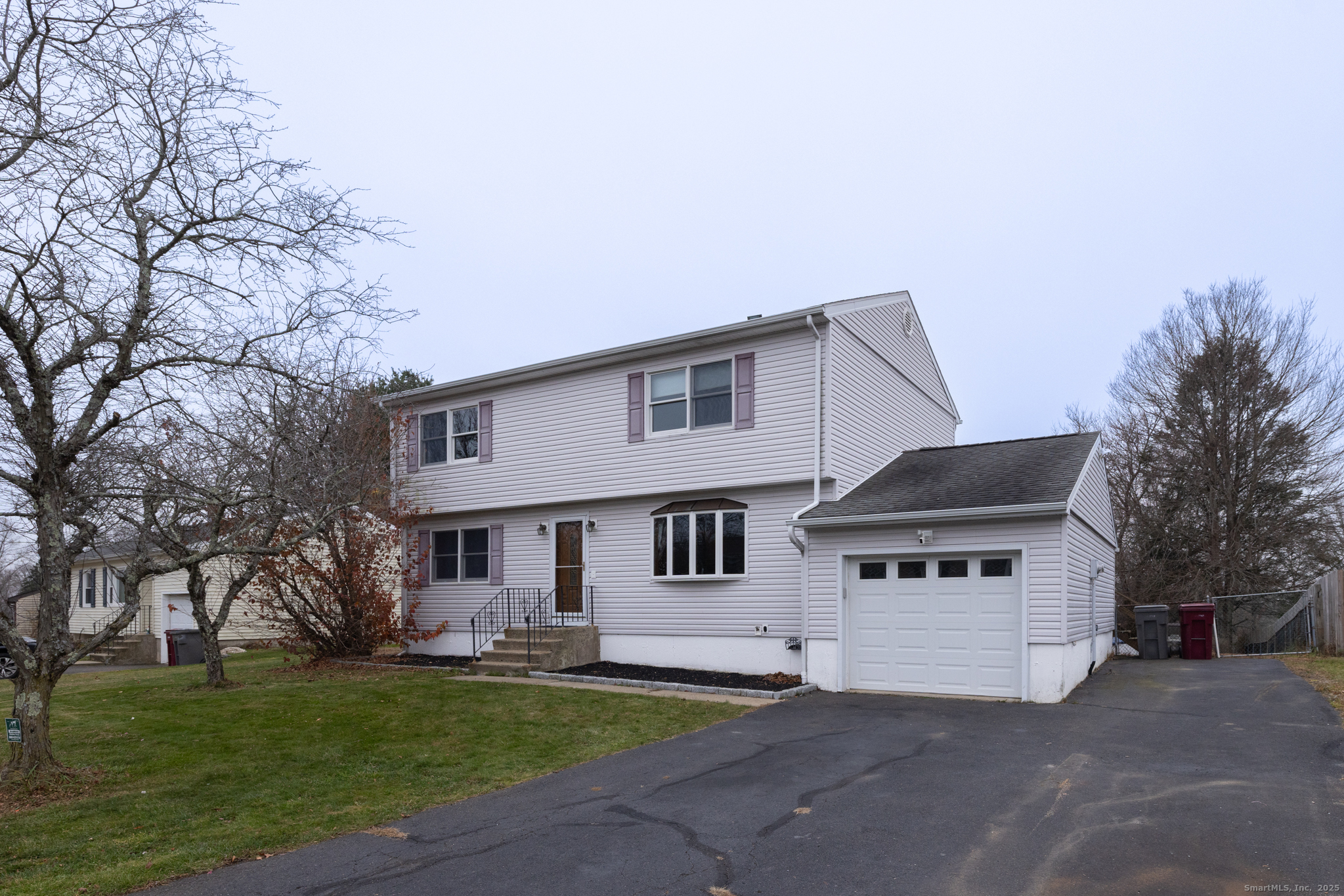93 Tawny Thrush Road Naugatuck, CT 06770 - Photo 2 of 33 a front view of a house with a garden and tree