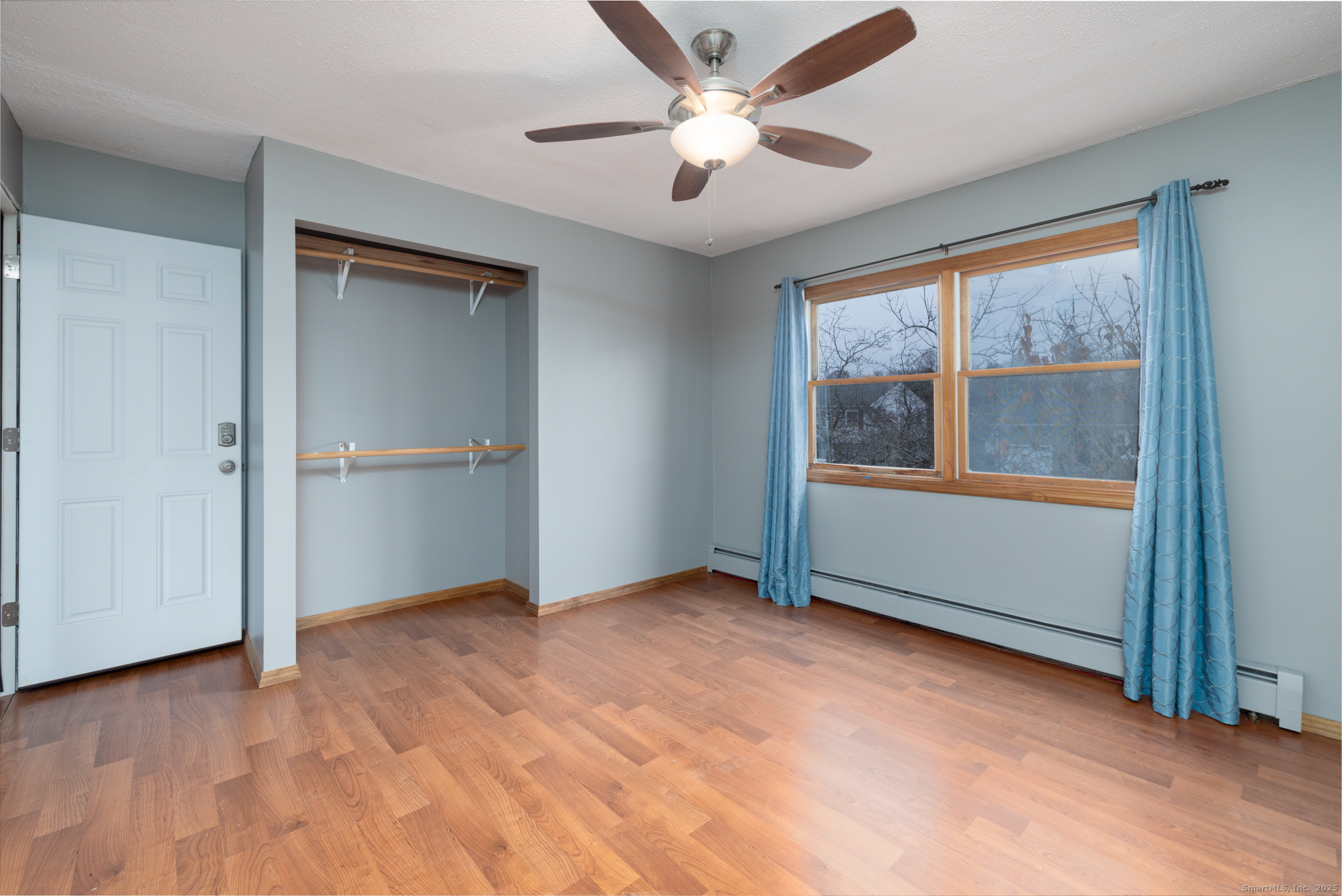 93 Tawny Thrush Road Naugatuck, CT 06770 - Photo 22 of 33 an empty room with chandelier fan and windows