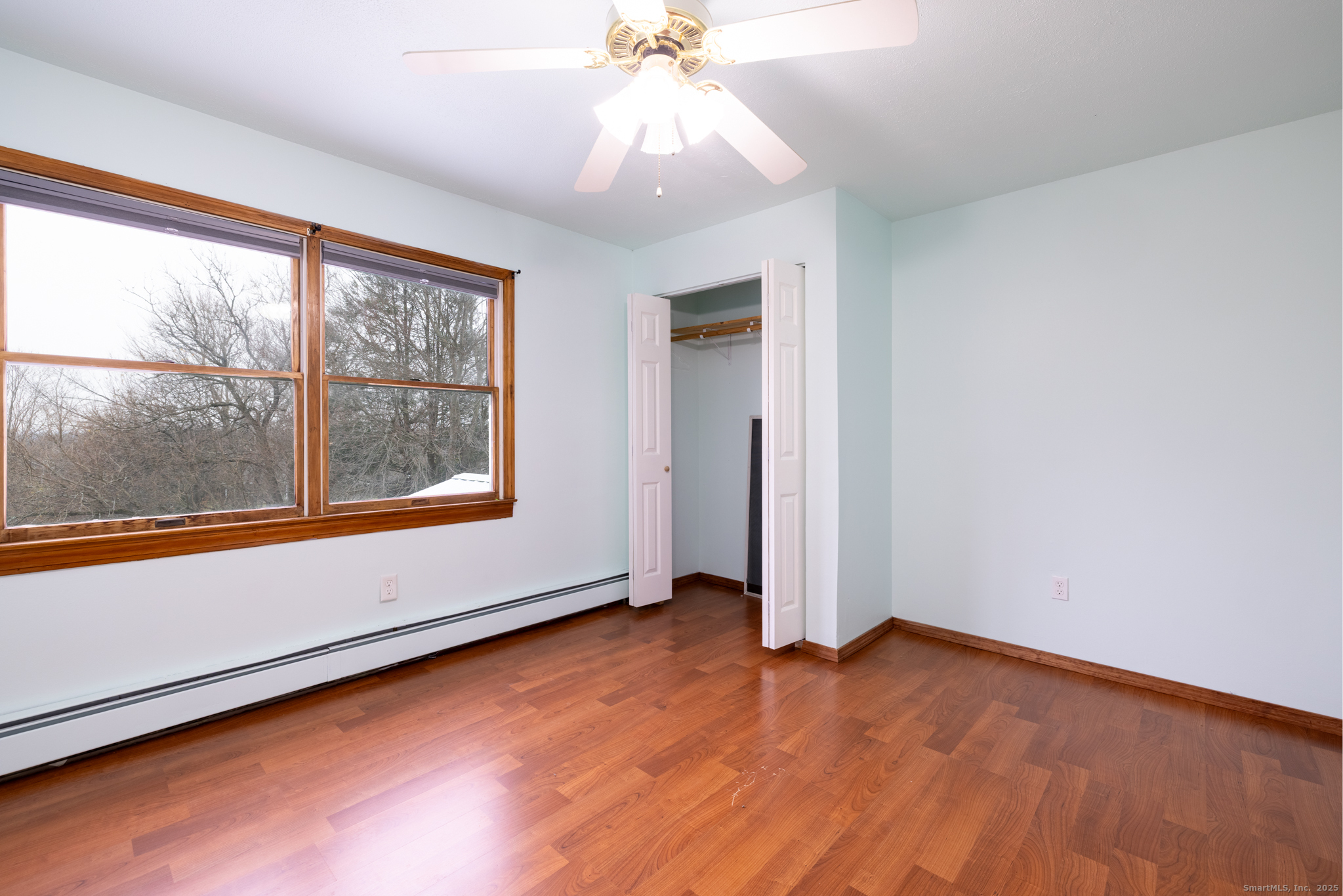 93 Tawny Thrush Road Naugatuck, CT 06770 - Photo 23 of 33 an empty room with wooden floor and windows