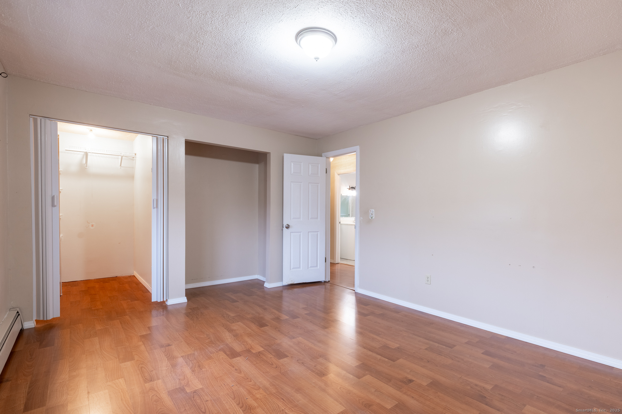 93 Tawny Thrush Road Naugatuck, CT 06770 - Photo 26 of 33 a view of an empty room and wooden floor