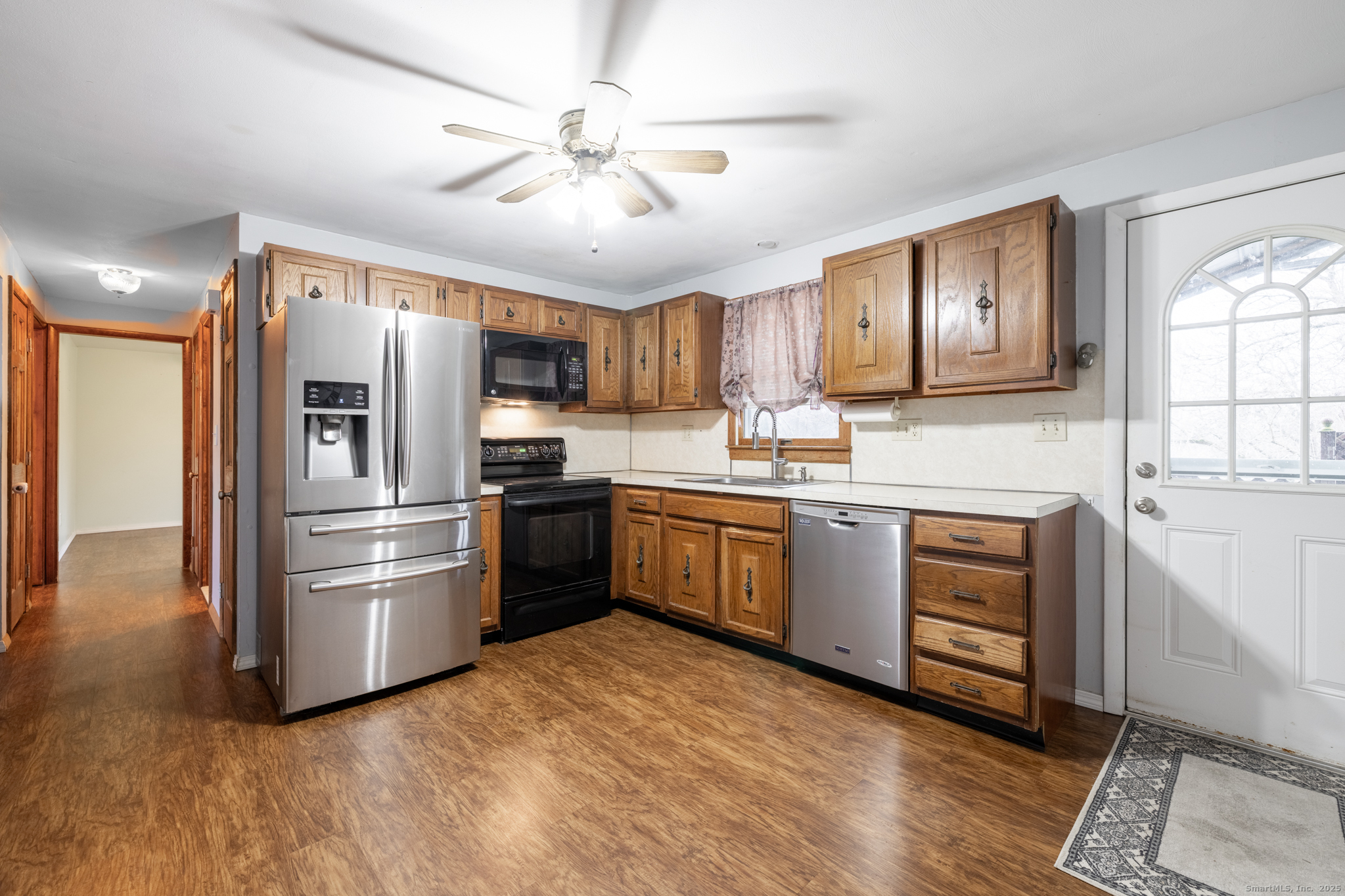 93 Tawny Thrush Road Naugatuck, CT 06770 - Photo 4 of 33 a kitchen with stainless steel appliances granite countertop a refrigerator a stove top oven a sink and dishwasher with wooden floor