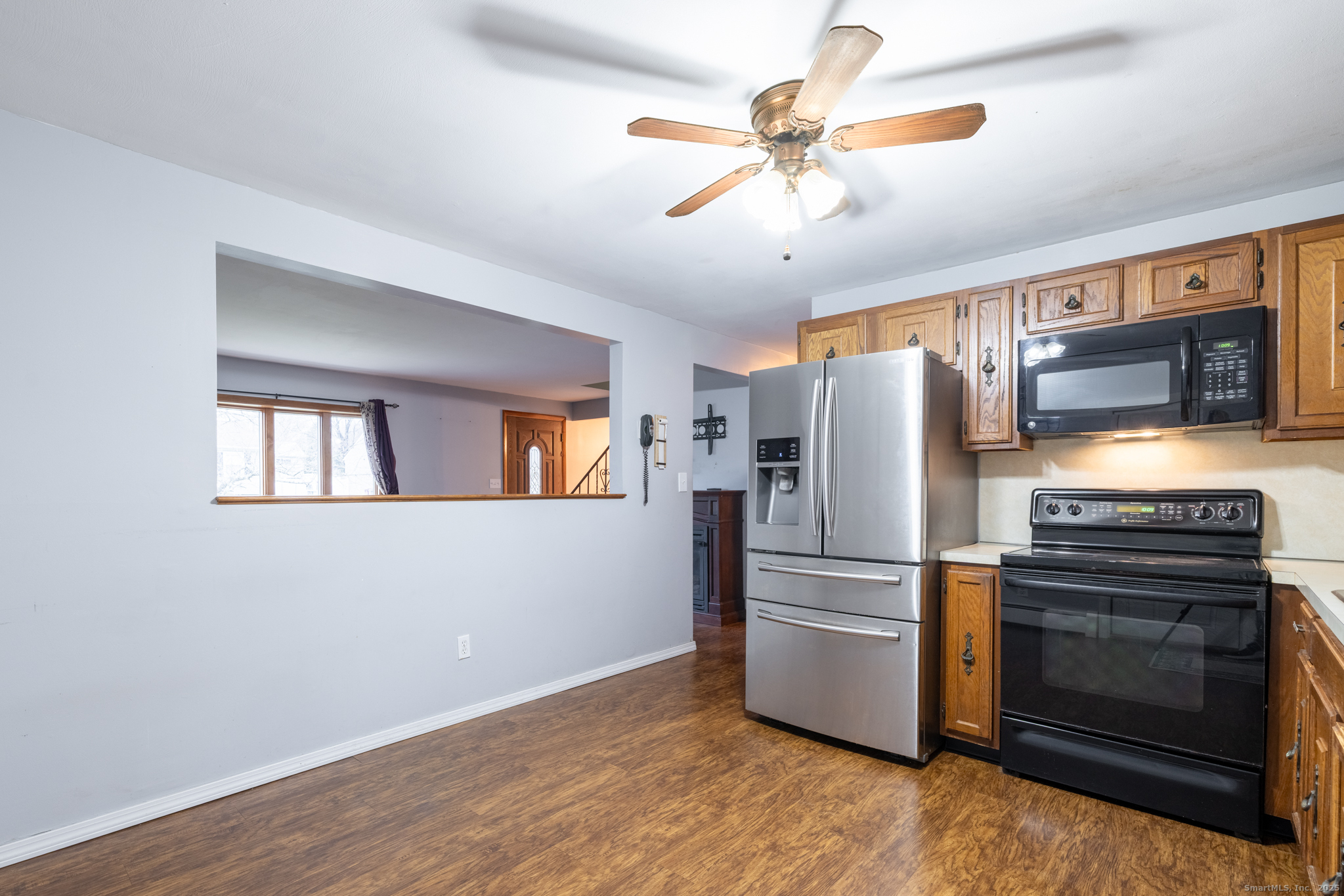 93 Tawny Thrush Road Naugatuck, CT 06770 - Photo 6 of 33 a kitchen with stainless steel appliances a stove a refrigerator and a microwave