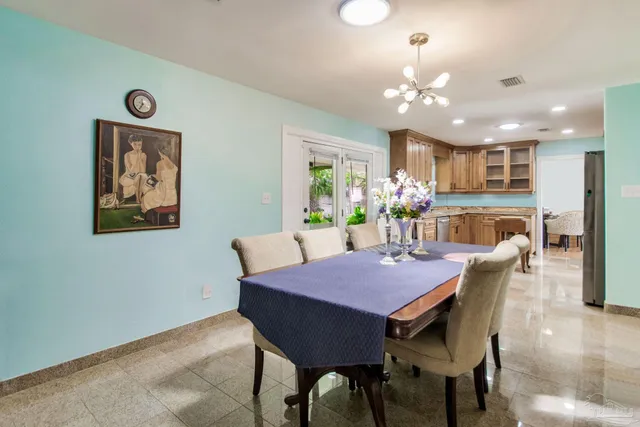a dining room with furniture and chandelier