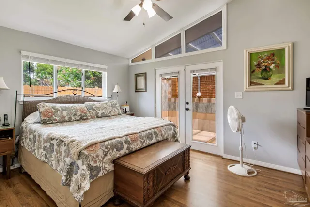 a bedroom with a bed wooden floor and window