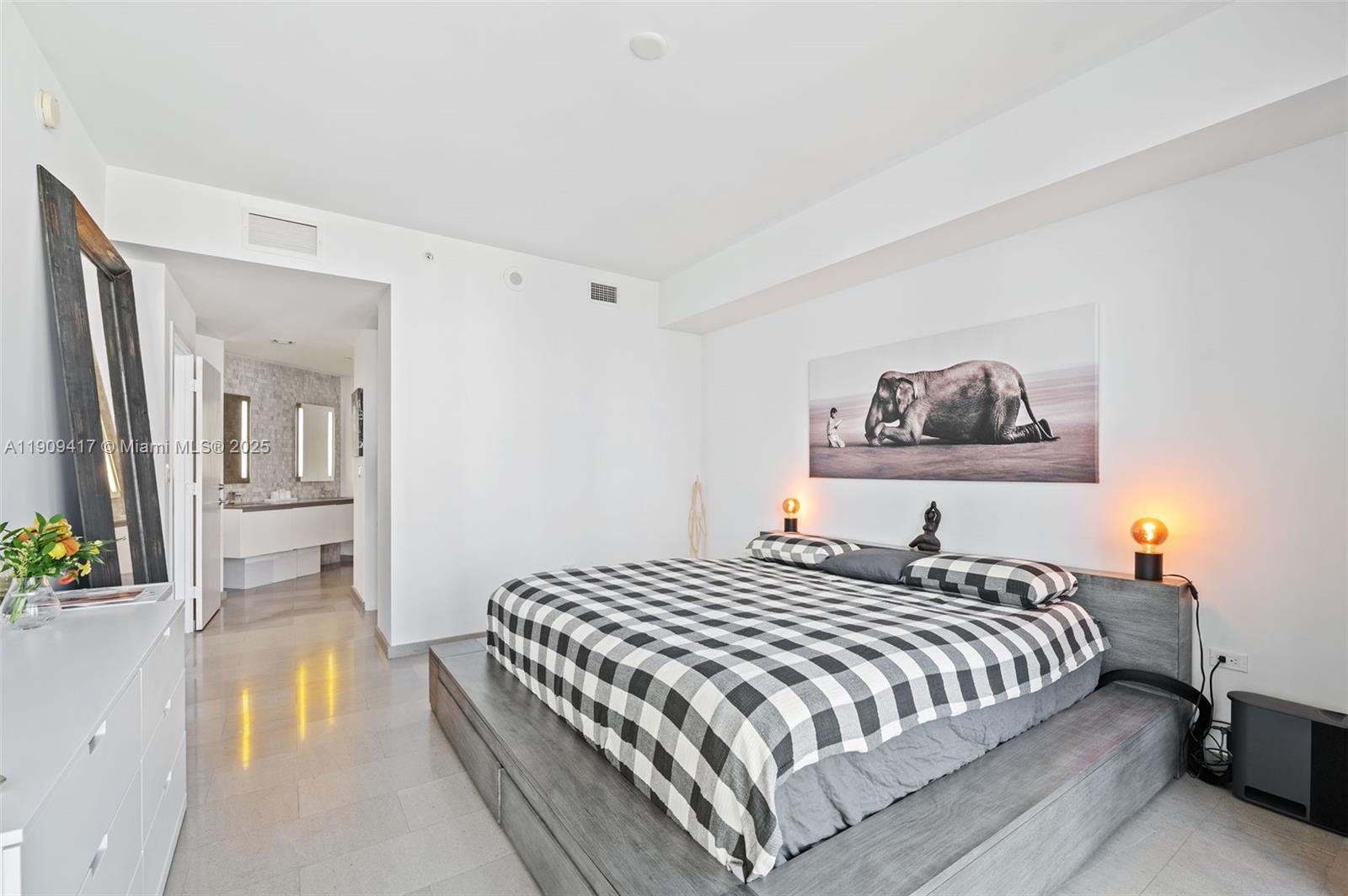 88 Southwest 7th Street, Unit 3101 Miami, FL 33130 - Photo 15 of 35 a bedroom with a bed and a painting on the wall