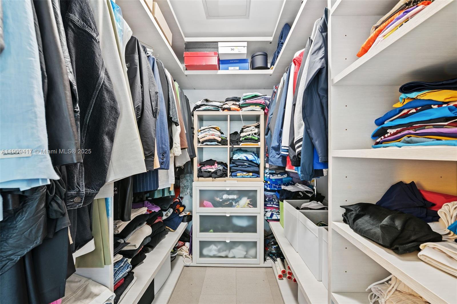 88 Southwest 7th Street, Unit 3101 Miami, FL 33130 - Photo 18 of 35 a view of walk in closet with clothes and shoes