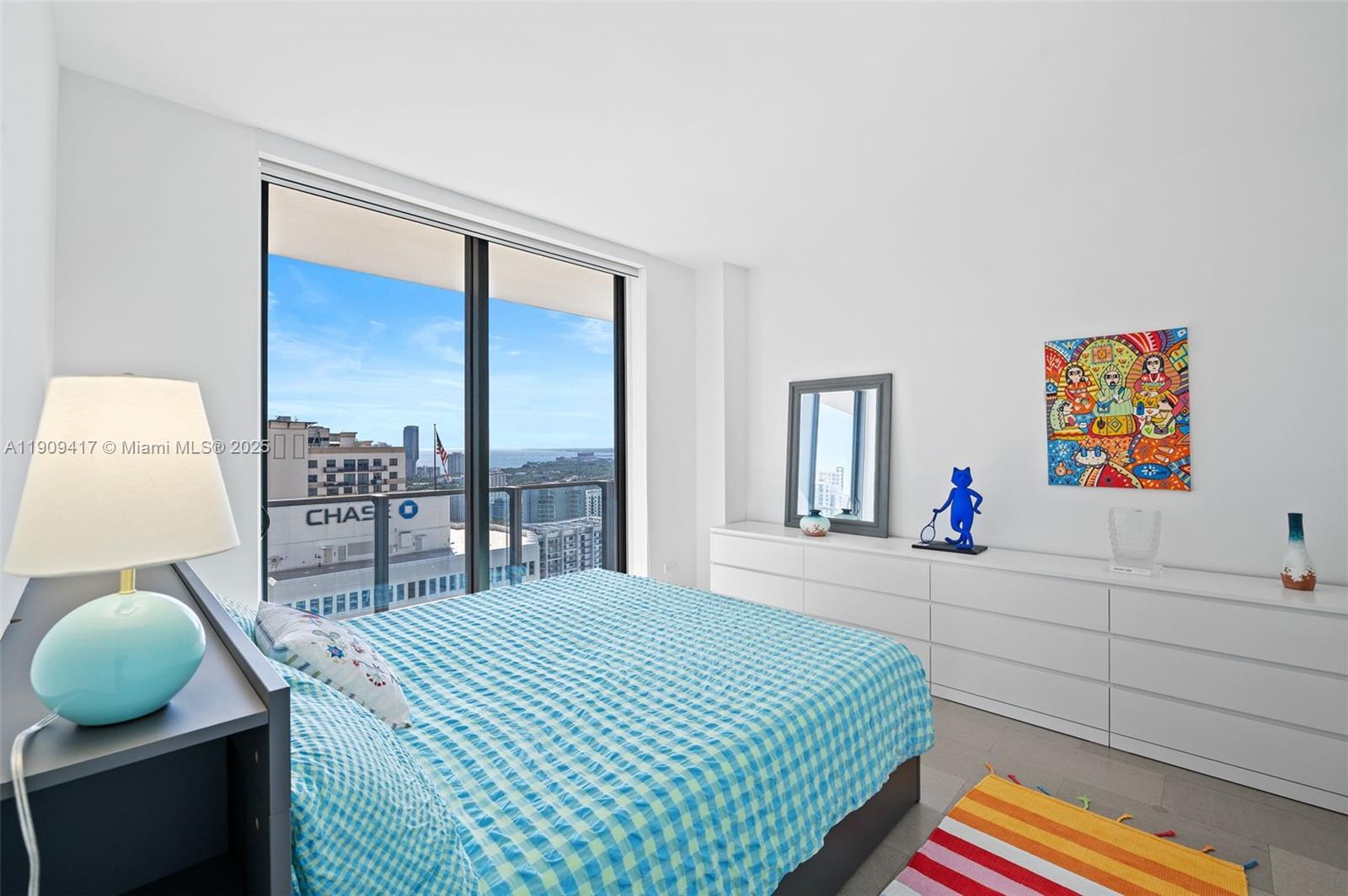 88 Southwest 7th Street, Unit 3101 Miami, FL 33130 - Photo 20 of 35 a bedroom with a bed and a painting on the wall